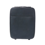 Front view of a black Louis Vuitton Pegase 45 Taiga leather rolling travel bag with zip closure, front pocket and visible wheels on a white background.