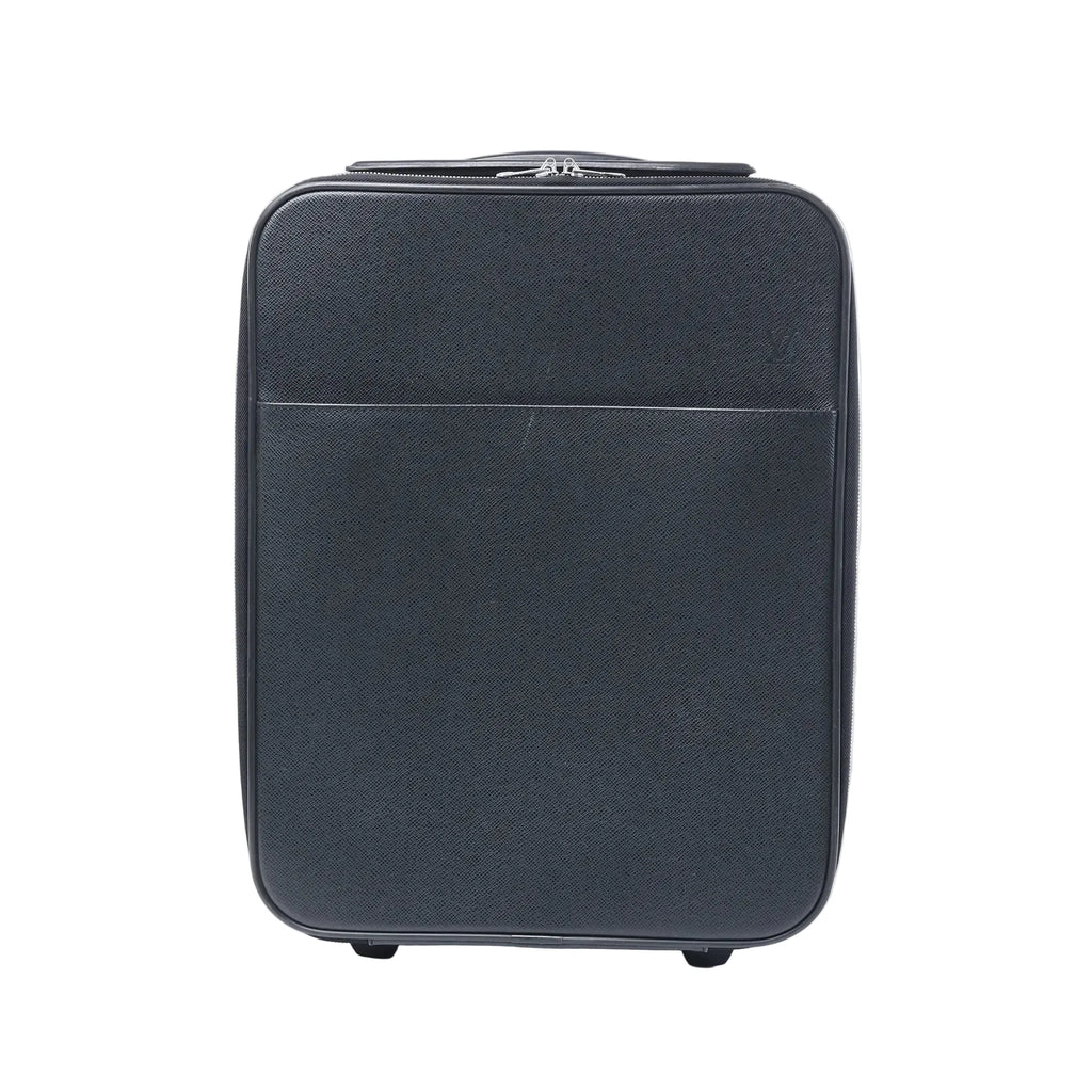 Front view of a black Louis Vuitton Pegase 45 Taiga leather rolling travel bag with zip closure, front pocket and visible wheels on a white background.