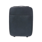 Front view of a black Louis Vuitton Pegase 45 Taiga leather rolling travel bag with zip closure, front pocket and visible wheels on a white background.