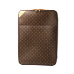 Louis Vuitton Pegase 65 rolling travel bag in brown Monogram canvas with zip closure and tan leather corner detail, front view on a white background.
