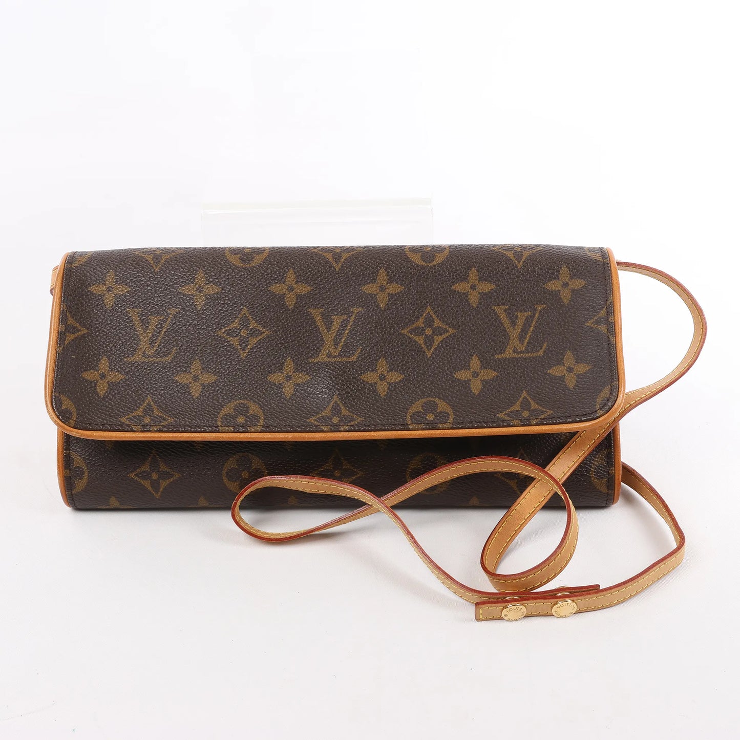Front view of the Louis Vuitton Monogram Canvas Pochette Twin GM Shoulder Bag M51852, featuring classic brown monogram canvas, natural leather trim, a long adjustable shoulder strap, and flap closure, displayed against a white background.