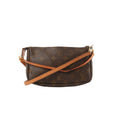 Louis Vuitton Pochette Accessoires Monogram canvas bag with vachetta leather crossbody strap across the front and gold-tone hardware on a white background.