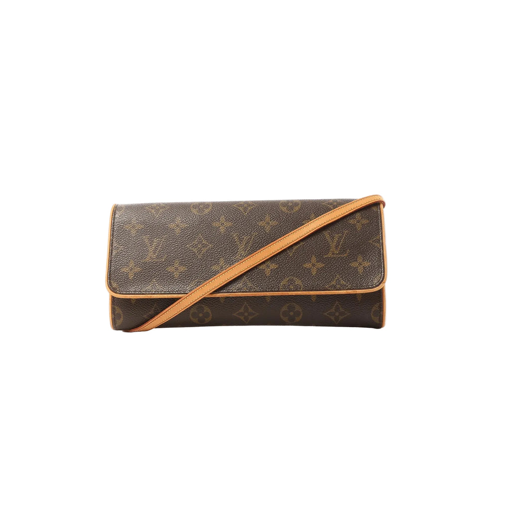 Louis Vuitton Pochette Twin GM crossbody bag in brown Monogram canvas with vachetta leather trim, flap front, and tan leather shoulder strap on white background.