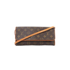 Louis Vuitton Pochette Twin GM Monogram canvas crossbody bag with flap front and vachetta leather trim and strap on white background.