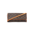 Louis Vuitton Pochette Twin GM Monogram canvas crossbody bag with flap front and vachetta leather trim and strap on white background.