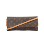 Louis Vuitton Pochette Twin GM shoulder bag in brown Monogram canvas with tan leather trim and slim strap on white background