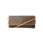 Louis Vuitton Pochette Twin GM crossbody bag in brown Monogram canvas with vachetta leather trim, flap front, and tan leather shoulder strap on white background.