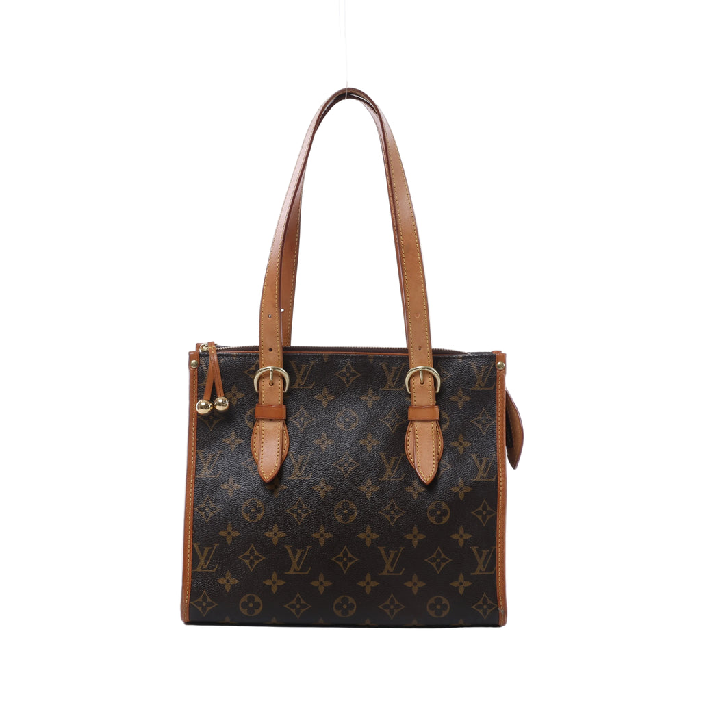 Louis Vuitton Monogram canvas shoulder bag with long tan leather straps, buckle details, gold-tone hardware and decorative zipper pulls.