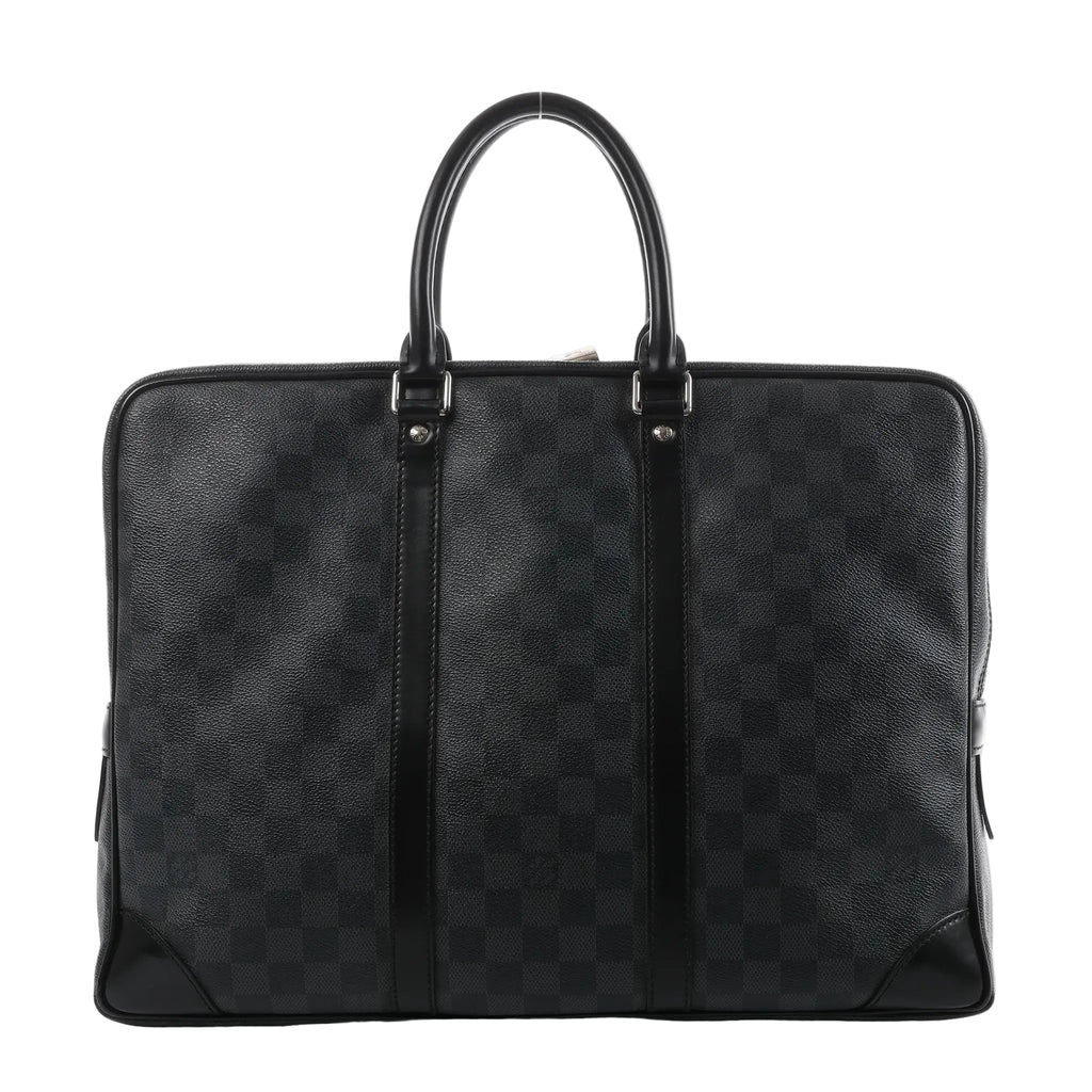 Louis Vuitton Porte Documents Voyage briefcase in dark gray Damier Graphite with black leather trim, two top handles, and zip-top closure on a white background.