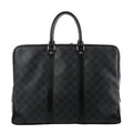 Louis Vuitton Porte Documents Voyage briefcase in dark gray Damier Graphite with black leather trim, two top handles, and zip-top closure on a white background.