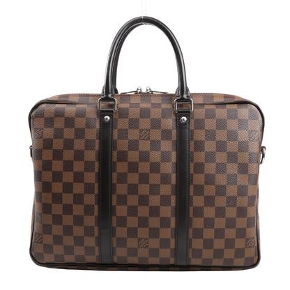 Louis Vuitton Porte Documents Voyages N41466 handbag in brown Damier Ebene coated canvas with dual black leather top handles, silver-tone hardware, and structured silhouette.