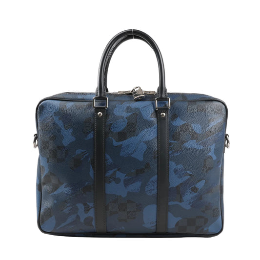Front view of Louis Vuitton Porte Documents Voyage PM in navy and black Damier Cobalt Camouflage canvas, featuring double top handles, silver-tone hardware, structured silhouette, and leather trim with signature checkerboard pattern blending into the camo print.