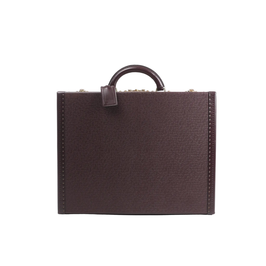 Front view of Louis Vuitton Président briefcase in purple Taiga leather with structured hard-case shape, top handle, and studded edge detailing.