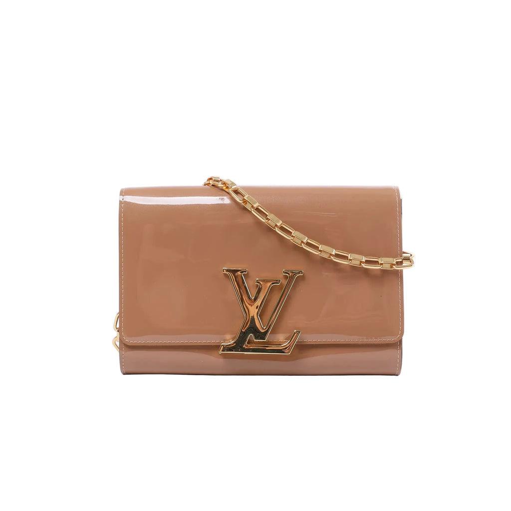 Louis Vuitton glossy beige patent leather clutch with oversized gold-tone LV clasp and rectangular-link chain strap.
