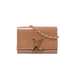 Louis Vuitton glossy beige patent leather clutch with oversized gold-tone LV clasp and rectangular-link chain strap.