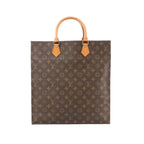Louis Vuitton Sac Plat tote in brown Monogram canvas with tan leather top handles and gold-tone handle tabs.