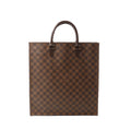 Louis Vuitton Sac Plat tote in brown Damier Ebene check canvas with dark leather top handles and gold-tone hardware, shown on a white background.