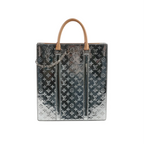 Louis Vuitton Sac Plat tote in reflective silver Monogram Mirror with tan top handles, embossed LV monogram pattern, and a silver chain detail on the front.