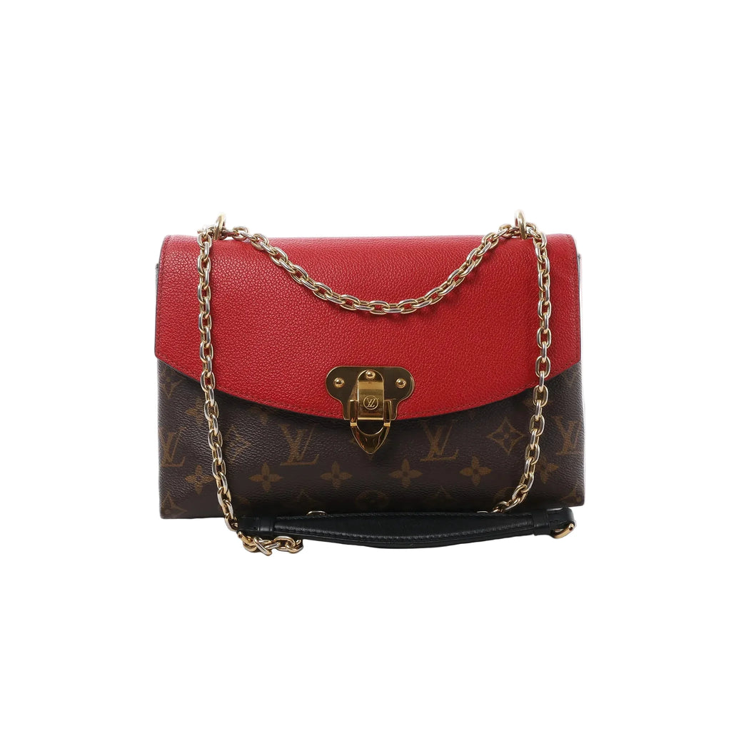Louis Vuitton Saint Placide crossbody in brown Monogram canvas with red leather flap, gold-tone clasp, and gold chain strap on a white background.