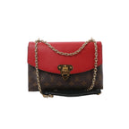 Louis Vuitton Saint Placide crossbody in brown Monogram canvas with red leather flap, gold-tone clasp, and gold chain strap on a white background.