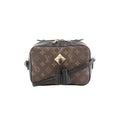 Louis Vuitton Saintonge crossbody bag in brown Monogram canvas with black leather trim, gold-tone front plaque, black tassel detail, and black shoulder strap.