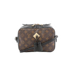 Louis Vuitton Saintonge crossbody bag in brown Monogram canvas with black leather trim, gold-tone front plaque, black tassel detail, and black shoulder strap.