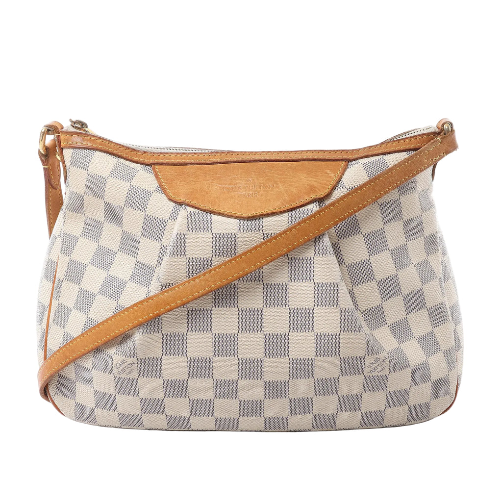 Louis Vuitton Siracusa PM crossbody bag in beige and white Damier Azur canvas with tan leather trim, top zip closure and adjustable strap.