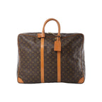 Louis Vuitton Sirius 55 monogram canvas travel bag in brown with tan vachetta leather straps, top handle, zip closure, and hanging luggage tag.