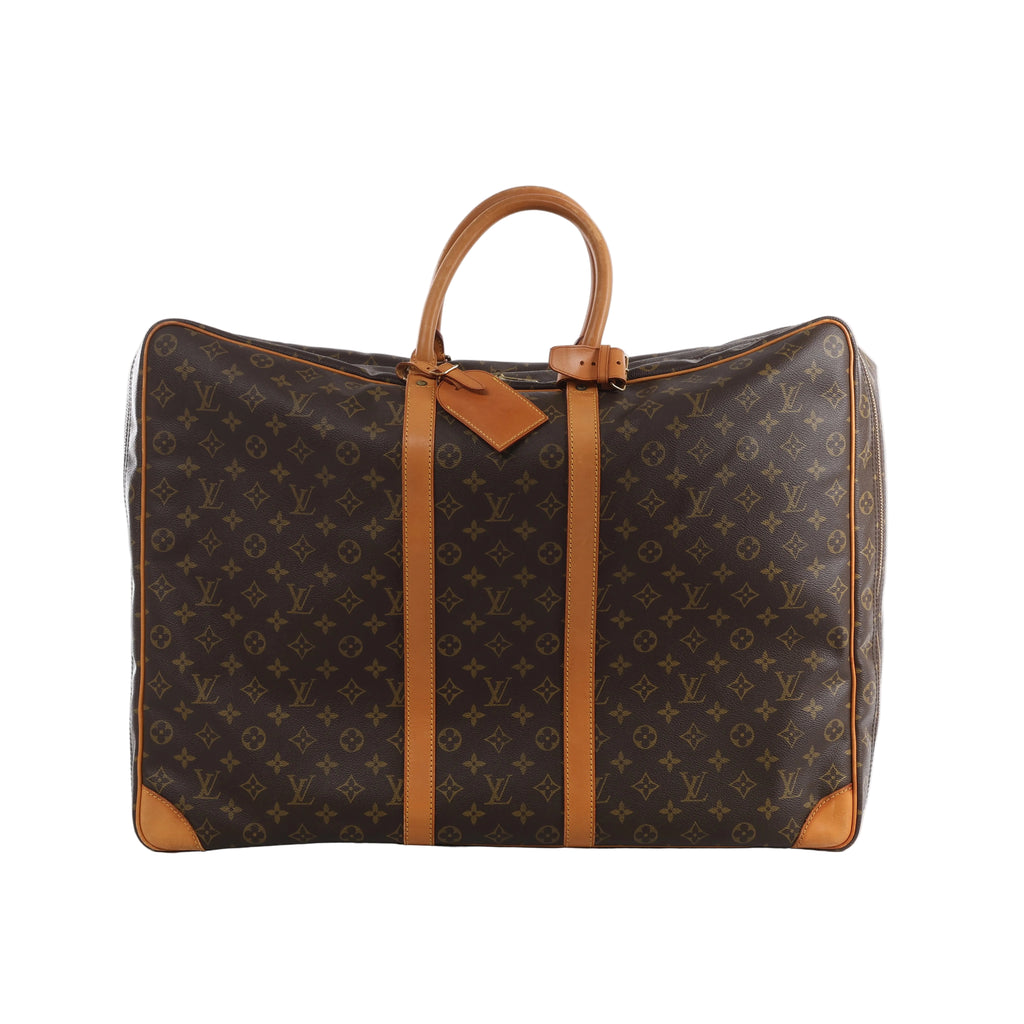 Brown Louis Vuitton Sirius 60 Monogram canvas travel bag with tan leather top handles, vertical trim, corner reinforcements and luggage tag.