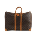Brown Louis Vuitton Sirius 60 Monogram canvas travel bag with tan leather top handles, vertical trim, corner reinforcements and luggage tag.