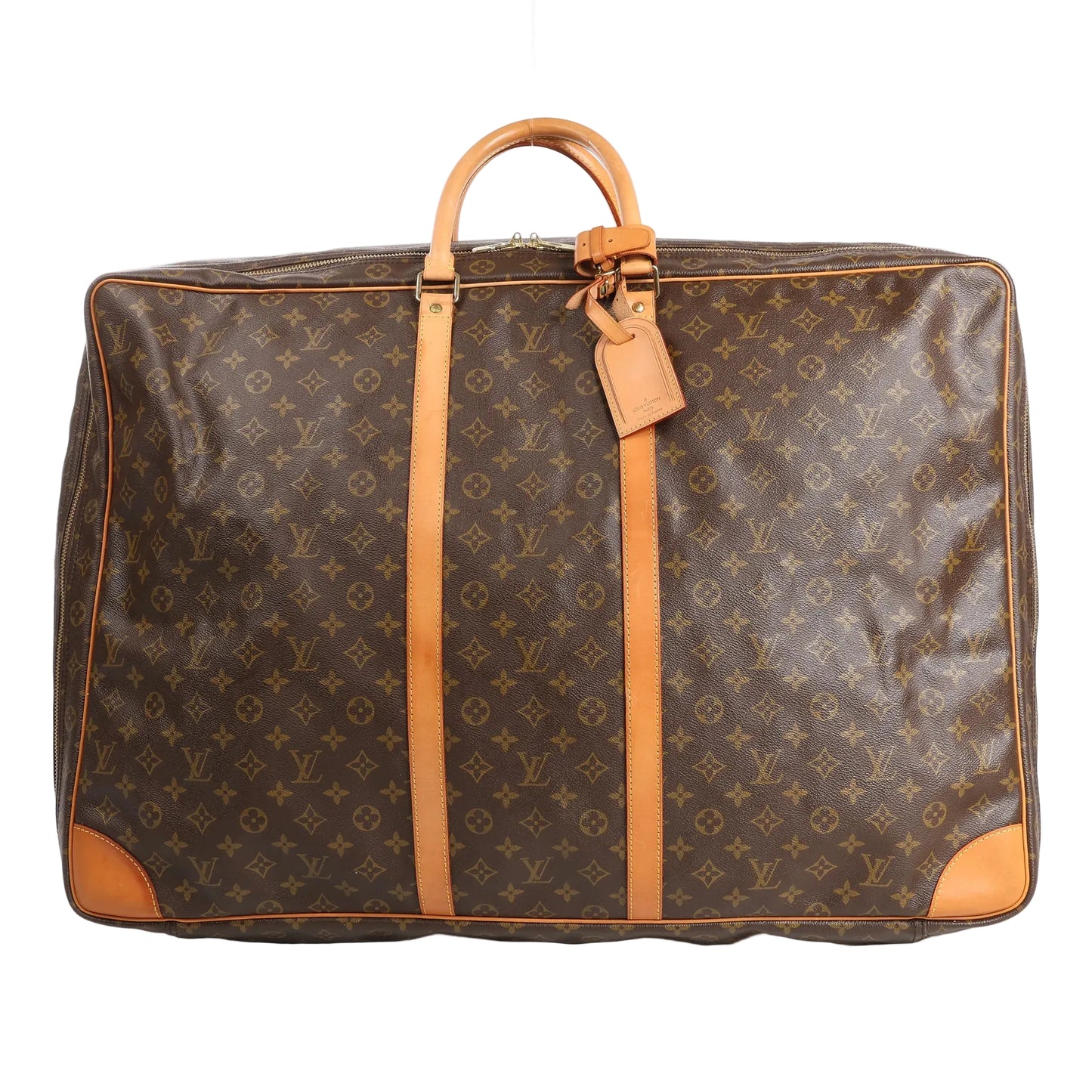 Louis Vuitton Sirius 65 travel bag in brown Monogram Canvas featuring natural Vachetta leather top handles, vertical leather trim, gold-tone hardware, and a large rectangular silhouette with rounded corners and luggage tag detail.