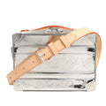 Louis Vuitton Soft Trunk M45885 crossbody bag in reflective silver monogram-embossed canvas, featuring natural leather adjustable strap, silver-tone hardware, reinforced corners, and a structured boxy silhouette inspired by classic LV trunks.