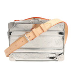 Louis Vuitton Soft Trunk M45885 crossbody bag in reflective silver monogram-embossed canvas, featuring natural leather adjustable strap, silver-tone hardware, reinforced corners, and a structured boxy silhouette inspired by classic LV trunks.