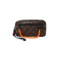 Brown Louis Vuitton Monogram Pochette Volga clutch with black front zip pocket, black leather wrist strap, and neon orange chain handle