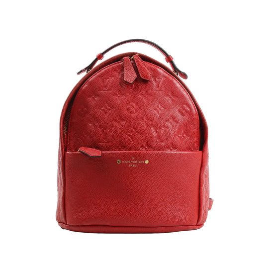 Louis Vuitton Sorbonne backpack M44015 in red Monogram Empreinte leather, featuring a structured design with top handle, front zip pocket, gold-tone hardware, and embossed LV monogram pattern throughout.