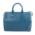 Louis Vuitton Speedy 25 handbag in blue Epi textured leather with dual top handles, zip-top closure, and LV logo on the front on white background