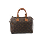 Louis Vuitton Speedy 25 handbag in brown Monogram canvas with natural leather top handles, gold-tone hardware, and zip-top closure.
