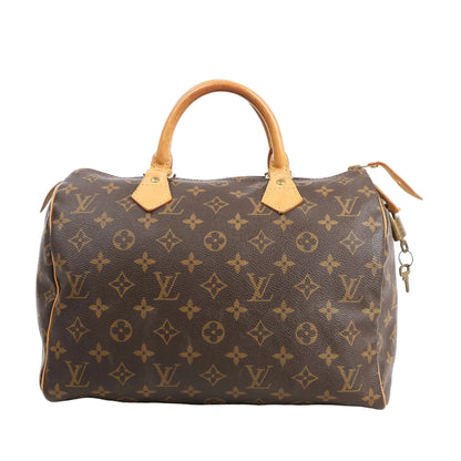 Front view of a Louis Vuitton Speedy 30 M41526 handbag in brown Monogram canvas, featuring natural leather handles, gold-tone hardware, and attached padlock with key.
