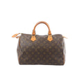 Front view of Louis Vuitton Speedy 30 handbag in brown Monogram canvas with vachetta leather top handles, gold-tone zipper, and leather trim.