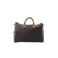 Louis Vuitton Speedy 30 handbag in brown Monogram canvas with tan vachetta leather handles, zip-top closure, and leather zipper pulls on white background.