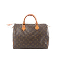 Louis Vuitton Speedy 30 handbag in brown Monogram canvas with natural leather top handles, gold-tone hardware, and zip-top closure on a white background.