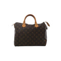 Front view of Louis Vuitton Speedy 30 handbag in brown Monogram canvas with vachetta leather top handles, zip-top closure, and hanging leather clochette with padlock.