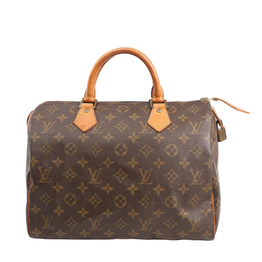 Louis Vuitton Speedy 30 handbag in brown Monogram canvas with rolled leather handles, gold-tone hardware, and classic barrel silhouette, shown on a white background.