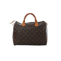 Louis Vuitton Speedy 30 Monogram canvas handbag with tan leather top handles, top zip closure, and brown monogram print on white background