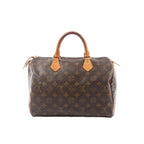 Louis Vuitton Speedy 30 handbag in brown Monogram canvas with tan vachetta leather top handles, top zip closure, and gold-tone hardware.