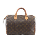 Louis Vuitton Speedy 30 brown Monogram canvas handbag with vachetta leather rolled top handles, vachetta trim, and top zip closure, shown on a white background.
