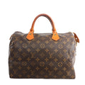 Louis Vuitton Speedy 30 handbag in brown Monogram coated canvas with natural cowhide leather rolled top handles, zip closure, and gold-tone hardware on a white background.