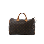 Front view of Louis Vuitton Speedy 35 handbag in brown Monogram canvas with vachetta leather top handles, zip-top closure, and side leather piping.