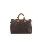 Louis Vuitton Speedy 35 handbag in brown Monogram canvas with tan leather top handles and top zip closure.