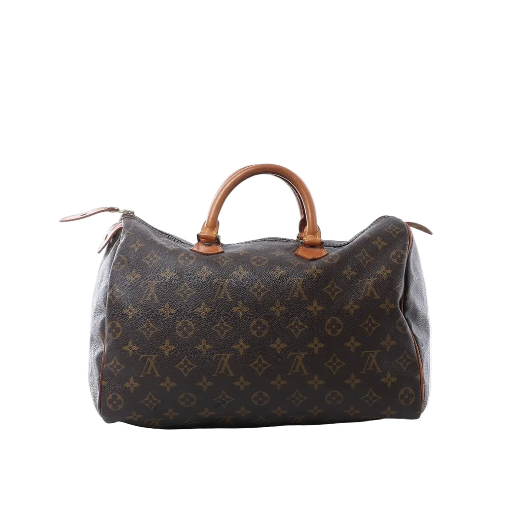 Louis Vuitton Speedy 35 handbag in brown Monogram canvas with tan vachetta leather handles, zip-top closure, and leather zipper pulls on white background.